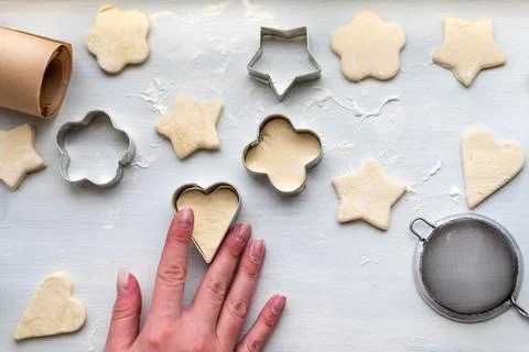 Top view of cooking a gingerbread cookie in the form of heart in female hand Stock Photos