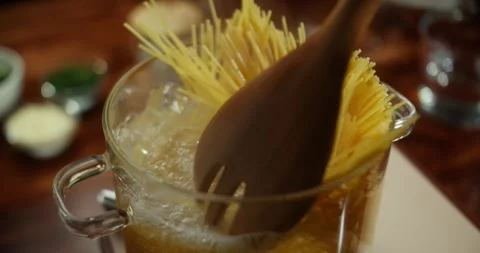 Top view. Cooking Spaghetti in boiling water in a transparent pan on a gas stove Stock Footage 316793804