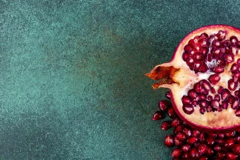 Top view copy space cut pomegranate on a green background Stock Photos