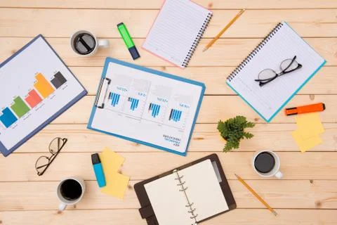 Top view with copy space. Office desk table with chart, notebook, pen, glasse Stock Photos