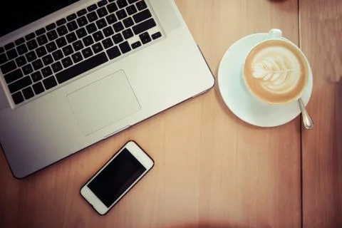 Top view with copy space, working desk with laptop cellphone and coffee in th Stock Photos