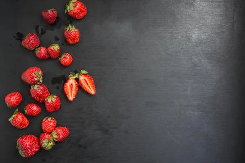 Top view copyspace, One cut strawberry among other whole Foto stock