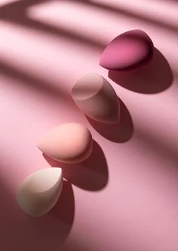 Top view of cosmetic blending applicators arranged in a diagonal line on a pi Stock Photos