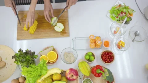 Top view of couple hands cutting fresh oranges with knife. Stock Footage 147377134