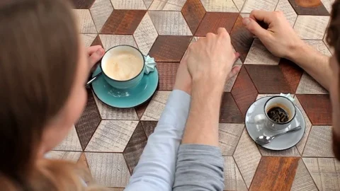 Top view. Couple holding hands at table Stock-Footage 83246424