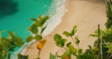 Top view of couple relaxing on sandy shore with turquoise sea water at Stock-Footage 341294879