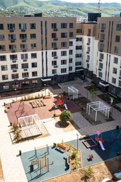 Top view of the courtyard of a multi-storey building with a playground Stock Photos