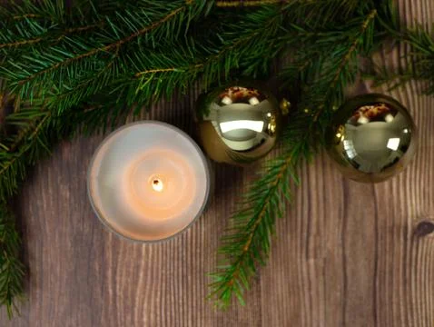 Top view cozy winter flat lay with burning candle, golden Christmas ornamen.. Stock Photos