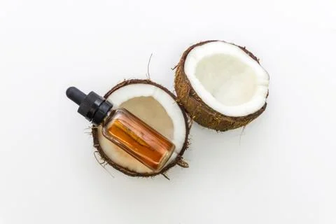 Top view of cracked Coconuts with Coconut essential oil in eyedropper isolate Stock Photos