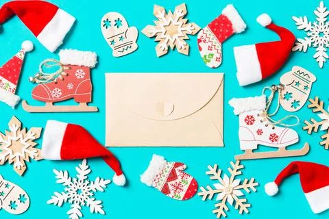 Top view of craft envelope with Christmas decorations and Santa hats on blu.. Stock Photos