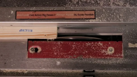 Top view. The craftman is working on electric saw machine. Sawing a board. Stock Footage 110350709