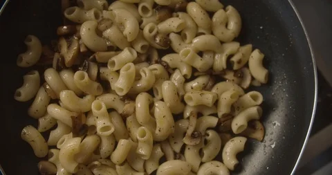 Top view cream and tomato paste poured into frying pan with pasta and mushrooms Stock Footage 113791036