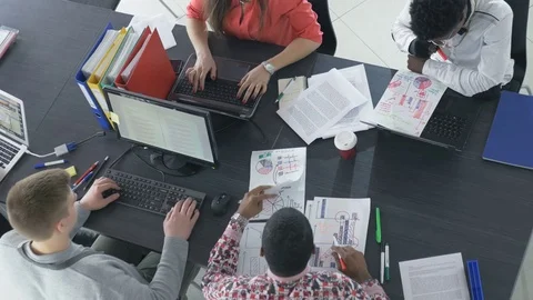 Top view of creative multiracial workers at their computers in the office Video stock 73850837