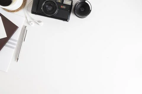 Top view creative working desk with camera, book, coffee cup and stationery.. Stock Photos
