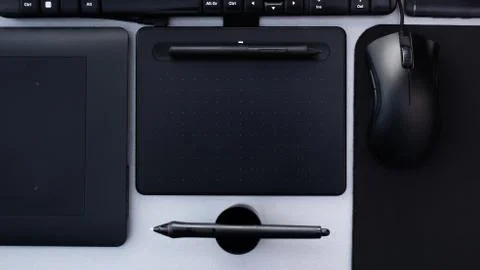 Top view of creative workspace with graphic tablet and pen Stock Photos
