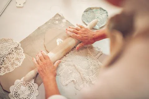 Top view of a crocheted napkin lying on the clay piece Stock Photos