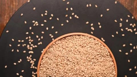 Top View of Cumin Seeds (Jeera) in White Bowl on Black Background Video stock 329340369