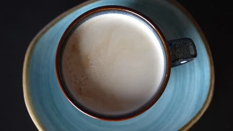 Top view on a cup and blue plate moving on turn table. Stock Footage 242716856