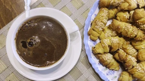 Top view of a cup of coffee and delicious homemade cookies with sesame seed.. Stock Footage 231616809