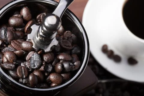 Top view cup of coffee and roasted coffee beans with coffee grinder Stock Photos
