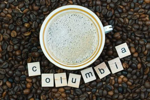Top view of a cup of coffee on a background coffee beans with the inscription Stock Photos