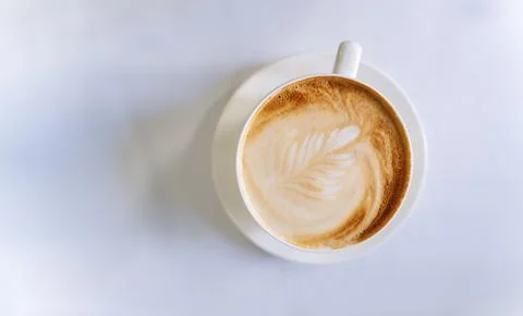 Top view on a cup of coffee. Coffee with a beautiful pattern on top of a wh.. Stock Photos