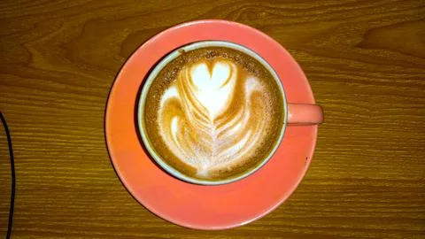 Top view of a cup of coffee with latte art on a wooden table Stock Photos
