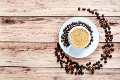 Top view of a cup of hot coffee on wooden rustic table with spilled coffee be Stock Photos