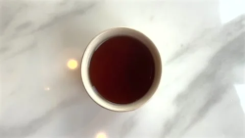 Top view of cup of hot tea with smoke on marble table Stock Footage 306128540