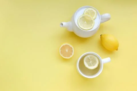 Top view of Cup of tea and fresh lemon on yellow background Stock Photos