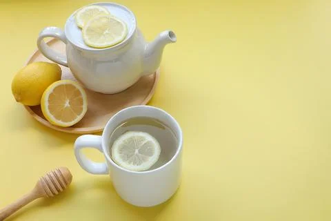 Top view of Cup of tea and fresh lemon on yellow background Stock Photos