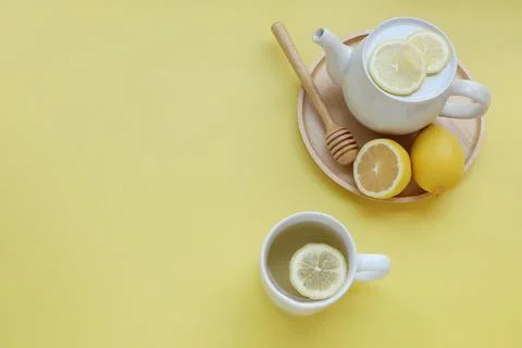 Top view of Cup of tea and fresh lemon on yellow background Stock Photos