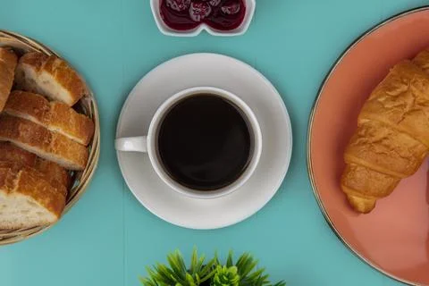 Top view of cup of tea and croissant sliced baguette with raspberry jam and.. Stock Photos