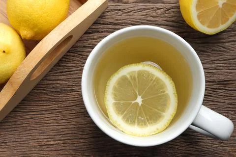 Top view, A cup of tea with fresh lemon on wooden table.  Stock Photos