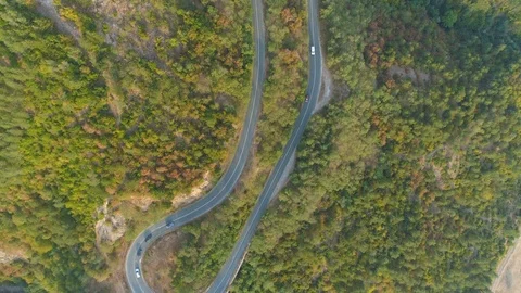 Top view of curvi mountain road with many cars driving. People on road trip Stock Footage 116475149