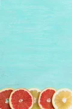 Top view on cut red and yellow grapefruit on turquoise wooden background. Jui Stock Photos