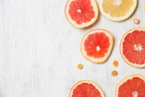 Top view on cut red and yellow grapefruit. Fresh organic citrus on white wood Stock Photos