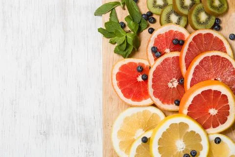 Top view on cut red and yellow grapefruit with mint. Fresh organic citrus, ki Stock Photos