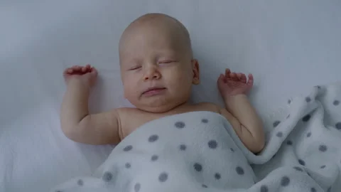 Top view, cute, beautiful, innocent newborn baby sleeping sweetly in bed Stock Footage 306043398