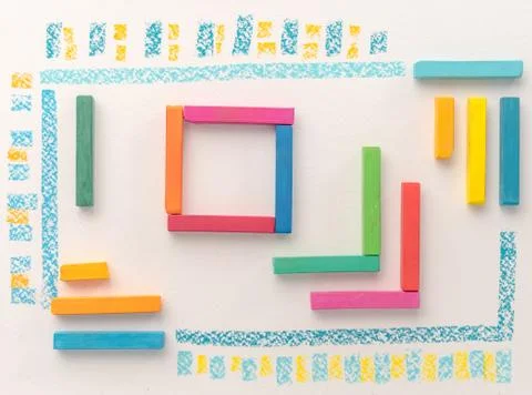 Top view of a cute geometric pattern made of colorful kid's pastel chalks Stock Photos