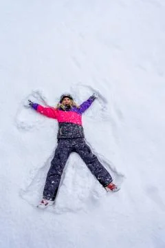 Top view of cute girl lying on snow 스톡 사진