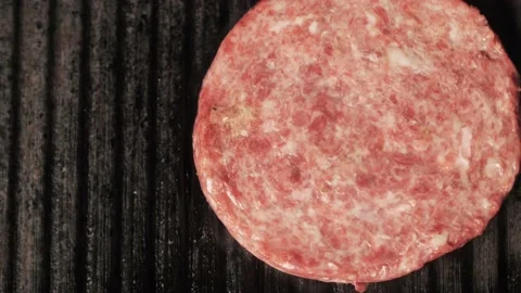 Top view on cutlet for burger and steak with rosemary frying on a hot grill pan Stock Footage 136055979