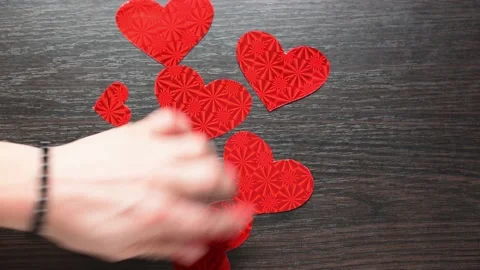 Top view of cutted red heart shapes on wooden background. St.Valentines day vide Stock Footage 232023190