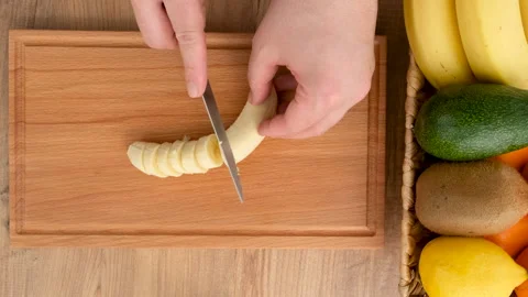 Top view of cutting banana on the kitchen table Stock Footage 273049150
