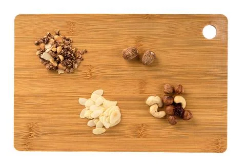 Top view of cutting board with nuts and muesli. Top view. Stock Photos
