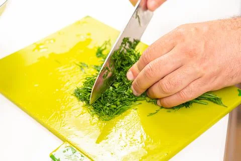 Top view cutting dill for making salad with kitchen knife Stock Photos