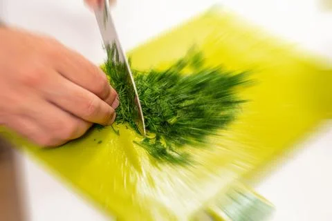 Top view cutting dill for making salad with kitchen knife Stock Photos