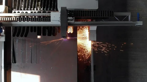 Top view of cutting a metal sheet with gas with flying sparks on a cnc machine Stock Footage 119909644