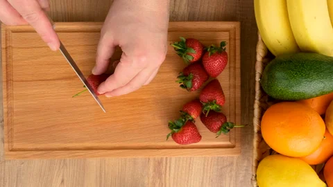 Top view of cutting strawberry on the kitchen table Stock Footage 273053305