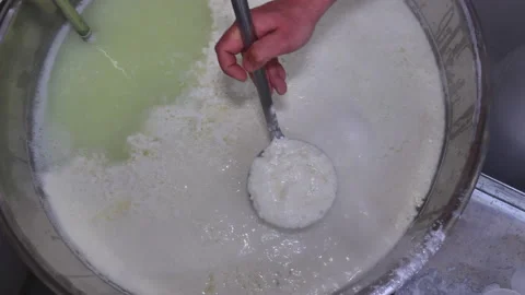 Top view of a dairyman puts hot ricotta cheese in plastic moulds Stock Footage 130879784